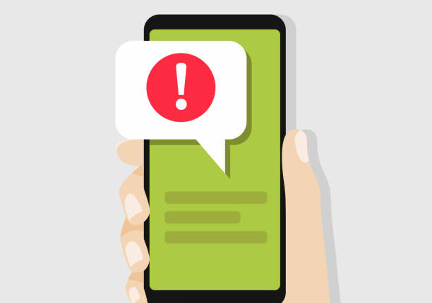 Hand holding smartphone with speech bubble and exclamation point icon. vector